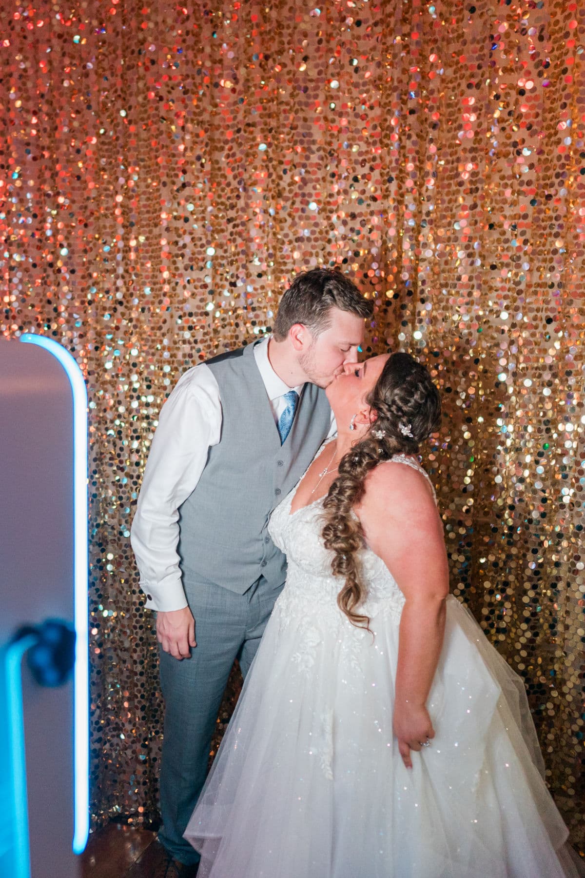 Bride and groom kissing in the booth