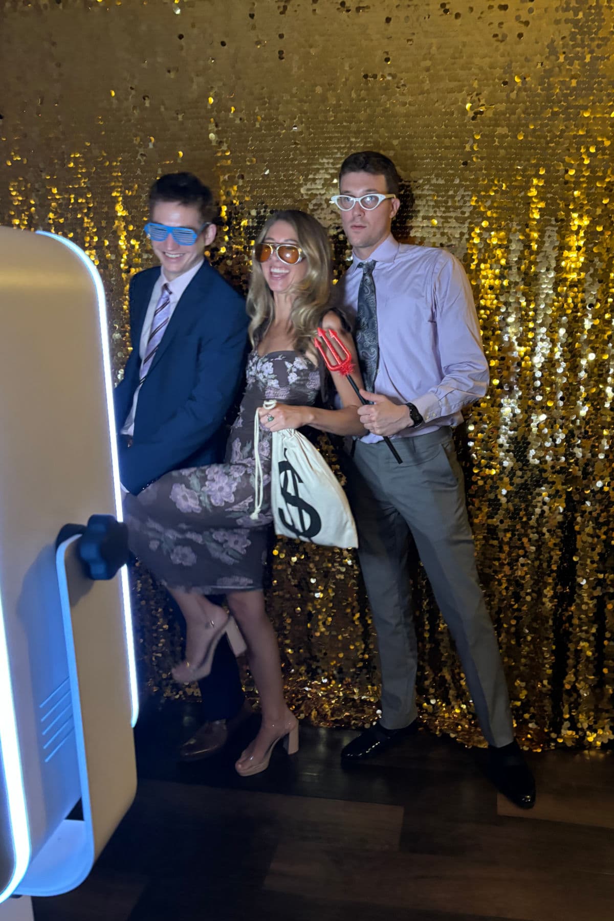 Trio posing in front of the gilded backdrop