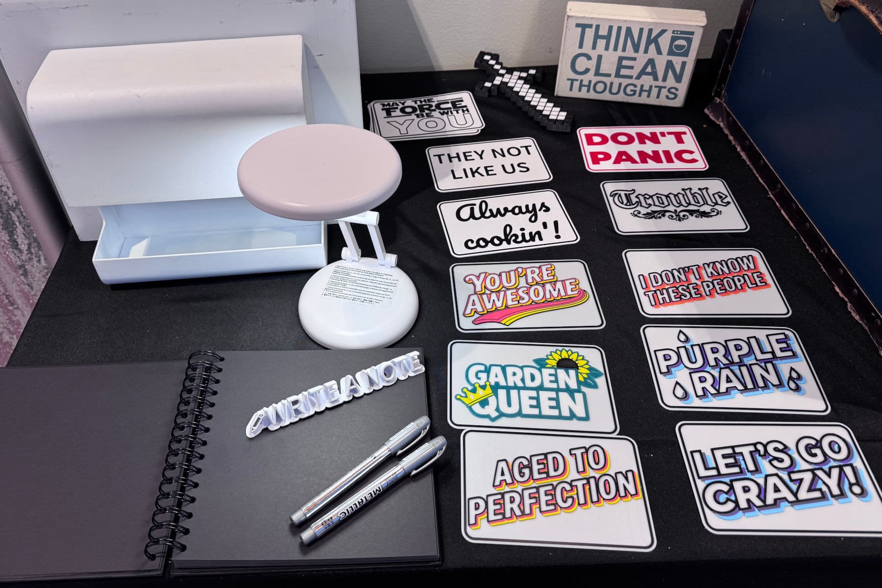 Custom 3D-printed hand props beside the scrapbook